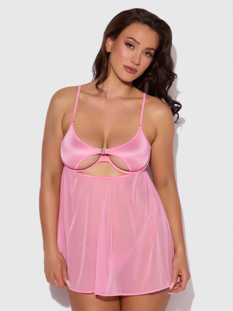 A woman poses against a neutral background wearing the Neev Oil Slick Openable Cup Underwire Babydoll by Frederick's of Hollywood, featuring pink satin and mesh with thin straps and a cutout below the bust.