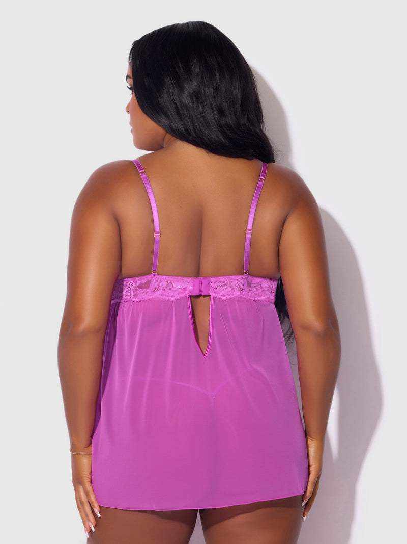 A woman with long dark hair is seen from the back wearing the Frederick's of Hollywood Arianna Lace & Chains Underwire Babydoll Set, featuring adjustable straps and a keyhole opening. The background is light gray.