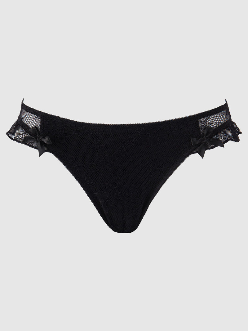 The Luella Lace Keyhole Back Hipster by Frederick's of Hollywood features black lace with mesh and ruffle detailing, accented by small black bows at the hips, shown on a plain light background.