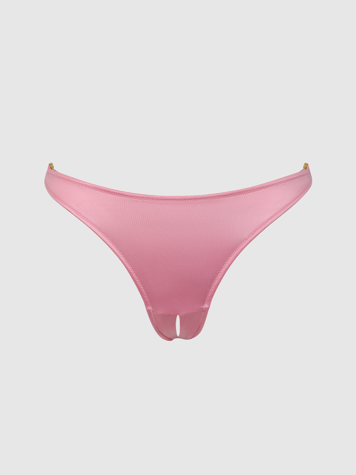 The Frederick's of Hollywood Rising Star Liquid Satin Crotchless Tanga is a pink, low-rise bikini bottom with gold hardware and a front cut-out, shown on a white background.