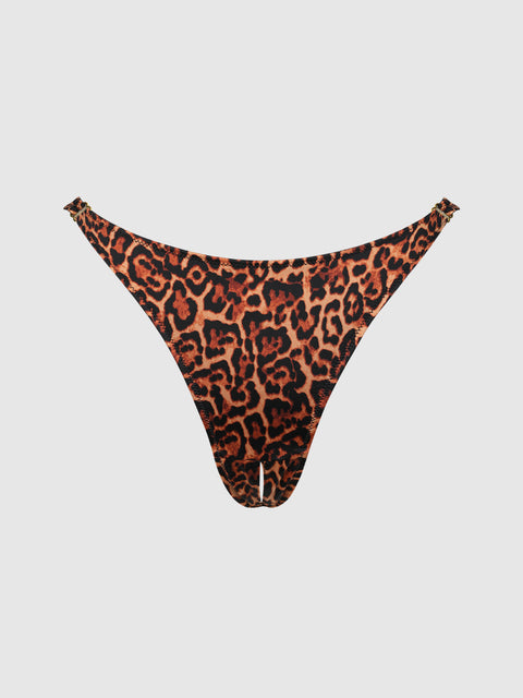 The Frederick's of Hollywood Rising Star Liquid Satin Crotchless Tanga features a bold orange and black leopard print with a high-cut fit, showcased against a plain white background.