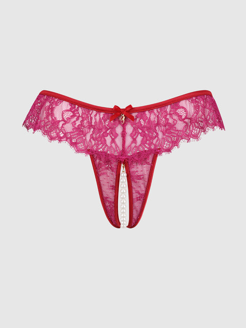 The Rosalind Lace & Pearl Crotchless Thong by Frederick's of Hollywood features red lace, a front bow, and elegant pearl accents in the open center, shown against a plain light background.