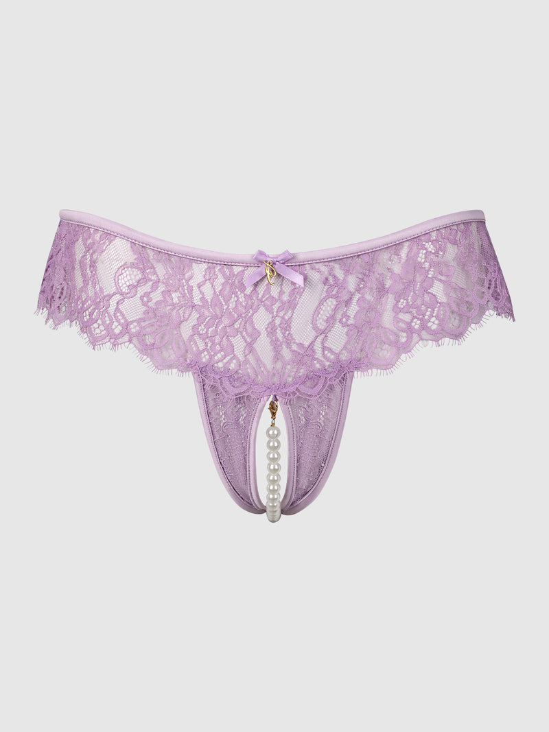 The Rosalind Lace & Pearl Open Thong by Frederick’s of Hollywood features lavender lace with a crotchless design, adorned with a small bow, gold accent, and decorative pearls at the front center, displayed on a plain white background.