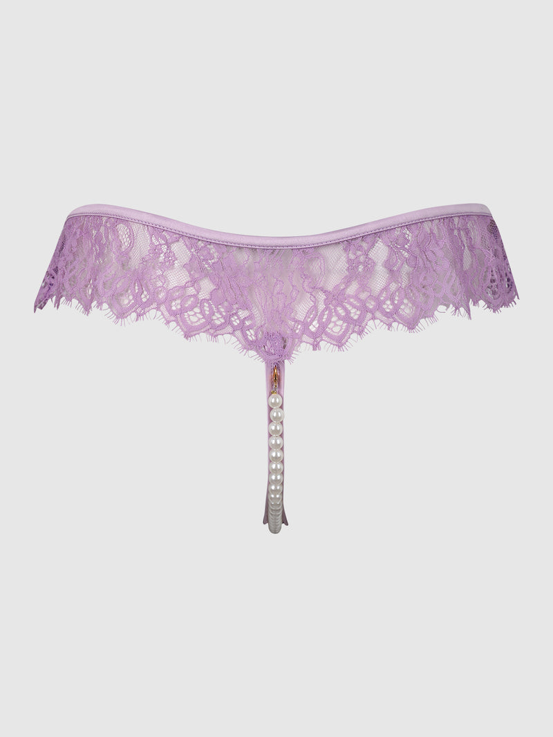 The Rosalind Lace & Pearl Open Thong by Frederick’s of Hollywood features delicate lavender lace with scalloped edges and a pearl-adorned string draping from the center, displayed against a plain white background.
