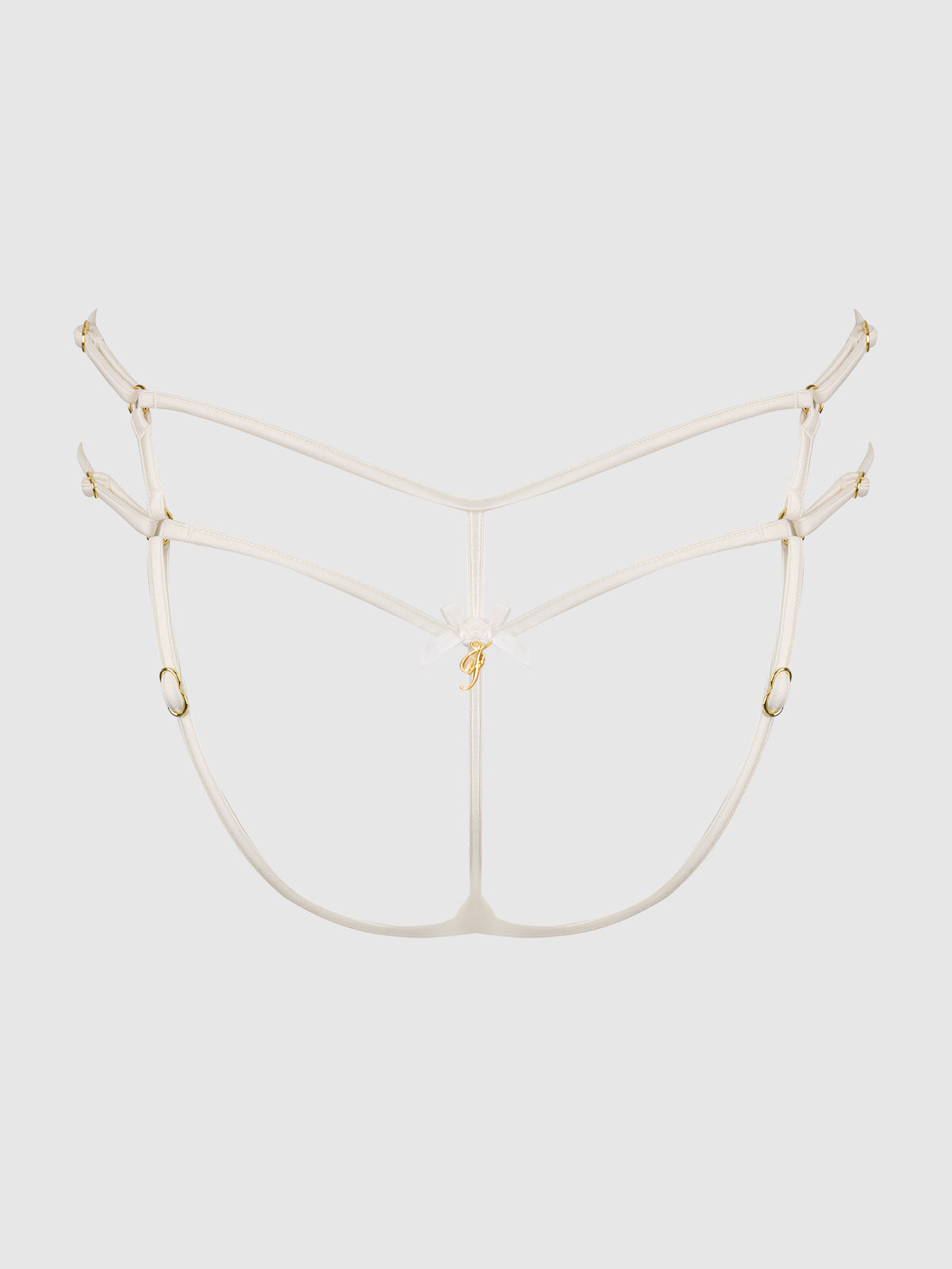 The Delfina Embroidered Backless Cheeky by Frederick's of Hollywood features delicate white strappy details, adjustable gold hardware, a central bow accent, and thin straps for a minimal, decorative look.
