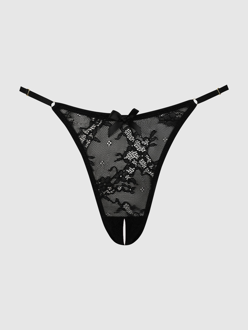 The Pia Lace Crotchless Side Slider Thong by Frederick's of Hollywood features black lace, adjustable straps, and a small front bow, shown on a plain light gray background.