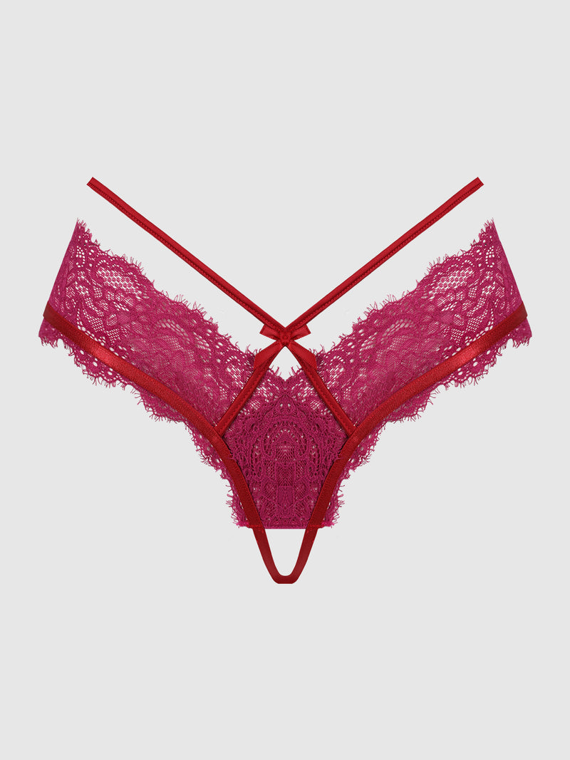 The Rosalind Crotchless Panty by Frederick’s of Hollywood features an alluring red lace design with intricate floral patterns, multiple slender straps, and a provocative cut-out front detail, beautifully styled and showcased against a simple light background.