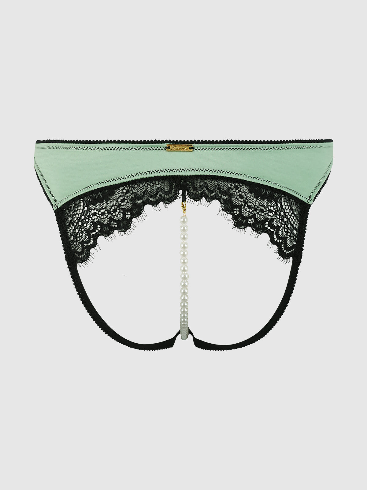 The Frederick's of Hollywood Lexi Lace Liquid Satin Open Back Hipster in mint green and black features a pearl string center, scalloped lace trim, and black elastic straps, shown on a plain white background.