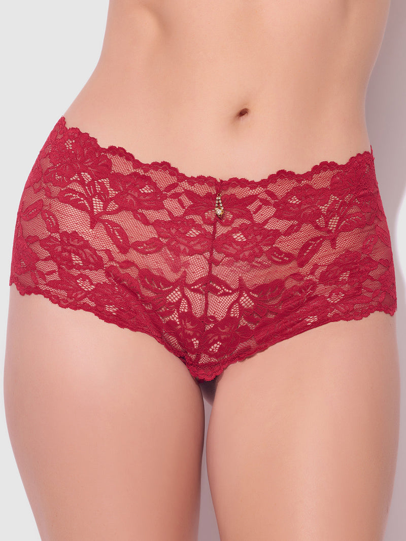 A close-up of a person wearing the Mabel Crotchless Lace Up Back Cheeky by Frederick's of Hollywood, featuring red floral lace and a small charm on the waistband. The background is plain and neutral.