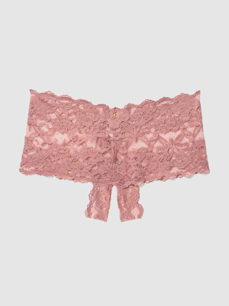 The Frederick's of Hollywood Mabel Crotchless Lace Up Back Cheeky is a pink floral lace panty with a cheeky open crotch design, shown flat on a light gray background for a sexy lingerie appeal.
