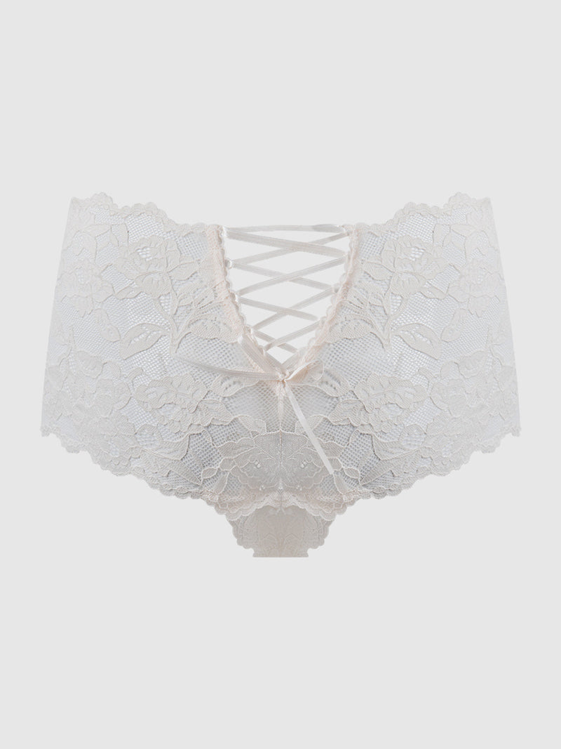 The Mabel Crotchless Lace Up Back Cheeky by Frederick's of Hollywood features ivory floral lace, a high-waisted fit, crisscross ribbon front, and cheeky cut. Set against a white backdrop, it showcases an elegant floral pattern.