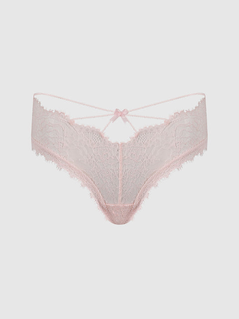 The Charlotte Lace & Mesh Hipster by Frederick’s of Hollywood features light pink lace with delicate scalloped edges, a strappy waistband, and a small bow detail at the front center, displayed on a plain white background.