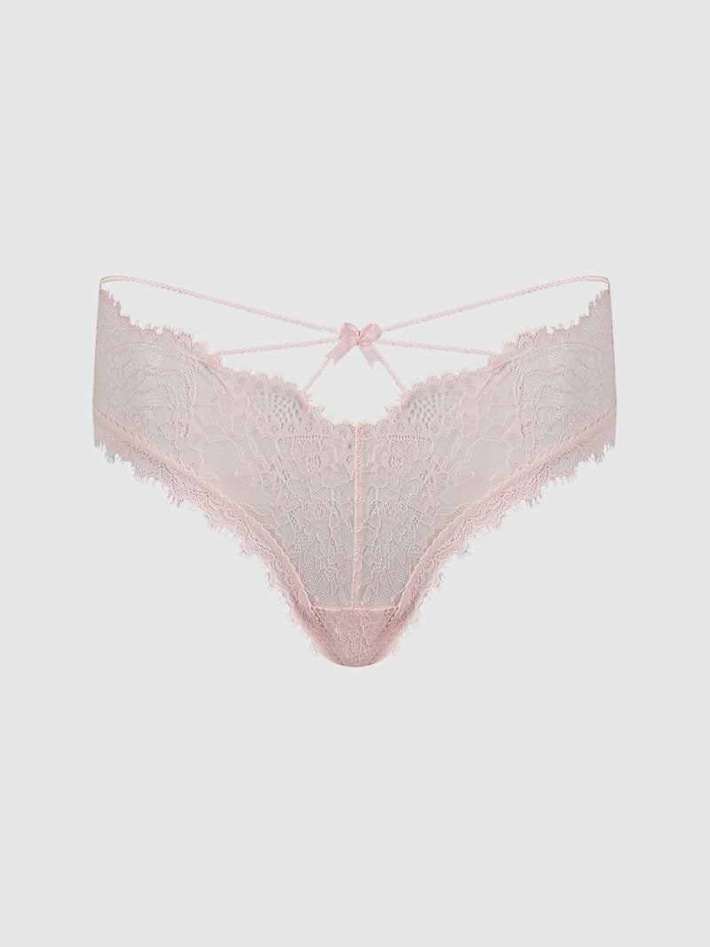The Charlotte Lace & Mesh Hipster by Frederick’s of Hollywood features light pink lace with delicate scalloped edges, a strappy waistband, and a small bow detail at the front center, displayed on a plain white background.