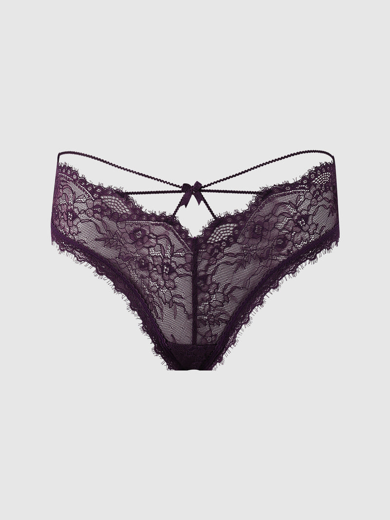 The Frederick’s of Hollywood Charlotte Lace & Mesh Hipster features sheer black lace with floral patterns, scalloped edges, and a small decorative bow at the front center, shown against a plain white background.