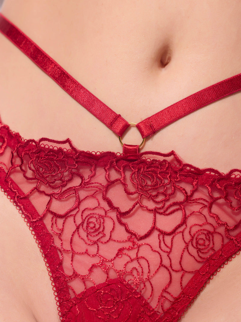 Close-up of the Melrose Embroidered Tanga by Frederick's of Hollywood, featuring red floral lace, decorative straps, and stretch mesh that flatters the lower abdomen and hips.