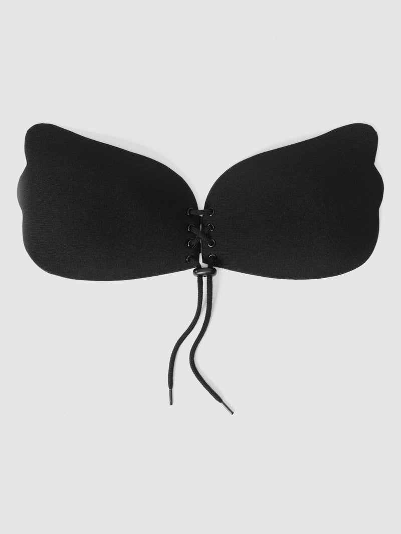 The Frederick's of Hollywood Tie Up Adhesive Bra is a black, strapless, butterfly-shaped backless bra with a lace-up front closure, shown against a plain white background.