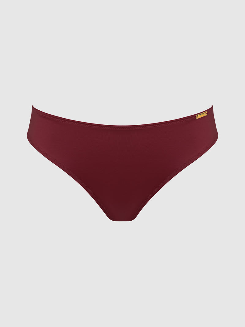 The Frederick's of Hollywood Lexi Liquid Satin Hipster features maroon bikini bottoms with a small gold-colored tag on the waistband, shown against a plain light gray background.