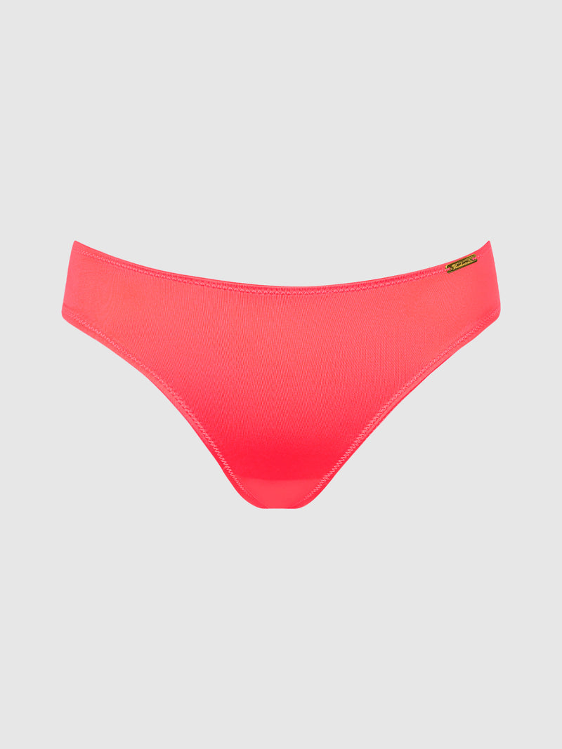 Coral pink Lexi Liquid Satin Hipster panties in silky fabric with a small metallic logo tag on the side.