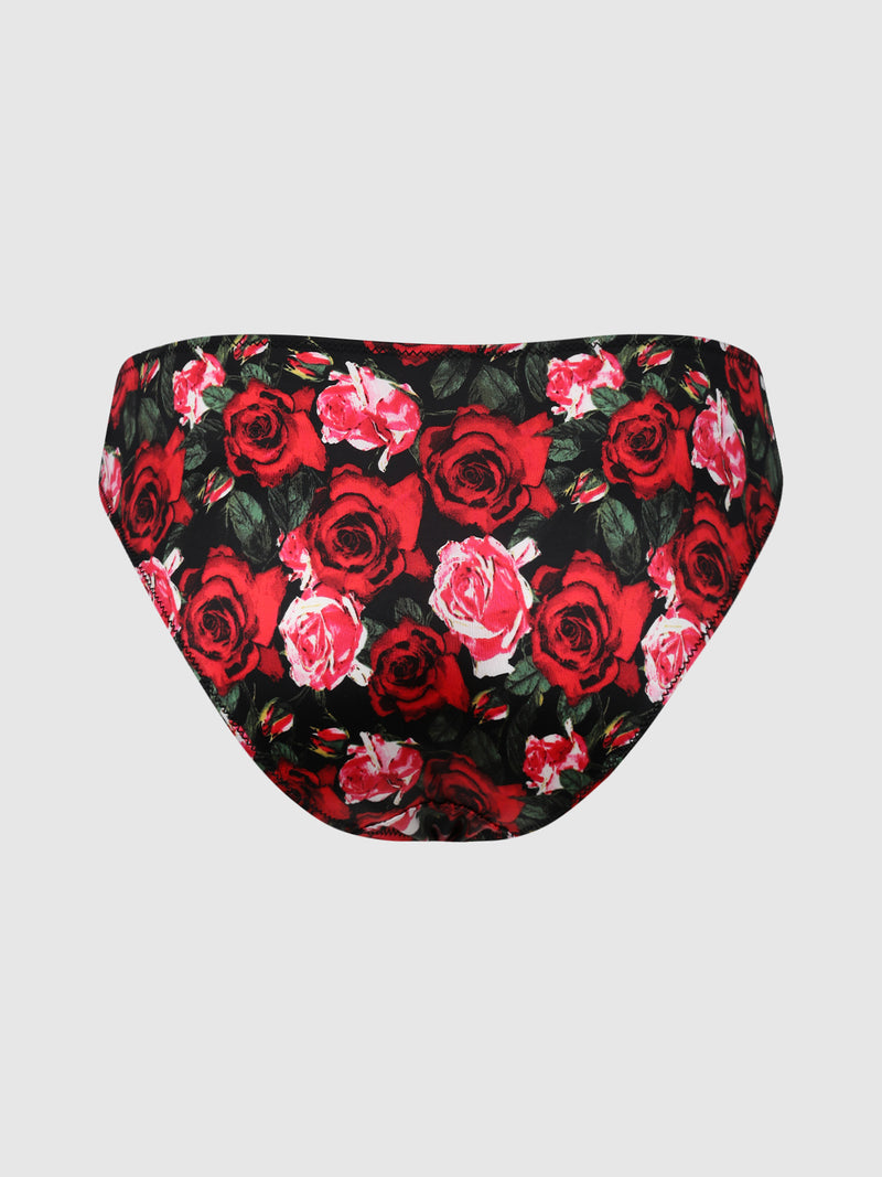 The Lexi Liquid Satin Hipster by Frederick’s of Hollywood, featuring a vibrant red and pink rose floral pattern on a black background, is displayed against a plain light gray backdrop.
