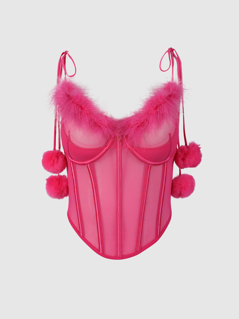 The Scarlett Marabou & Mesh Tie Shoulder Pom Pom Bustier by Frederick's of Hollywood features bright pink mesh, thin tie straps, fluffy trim along the neckline, furry pom poms on straps and sides, visible boning, and a playful bold look.