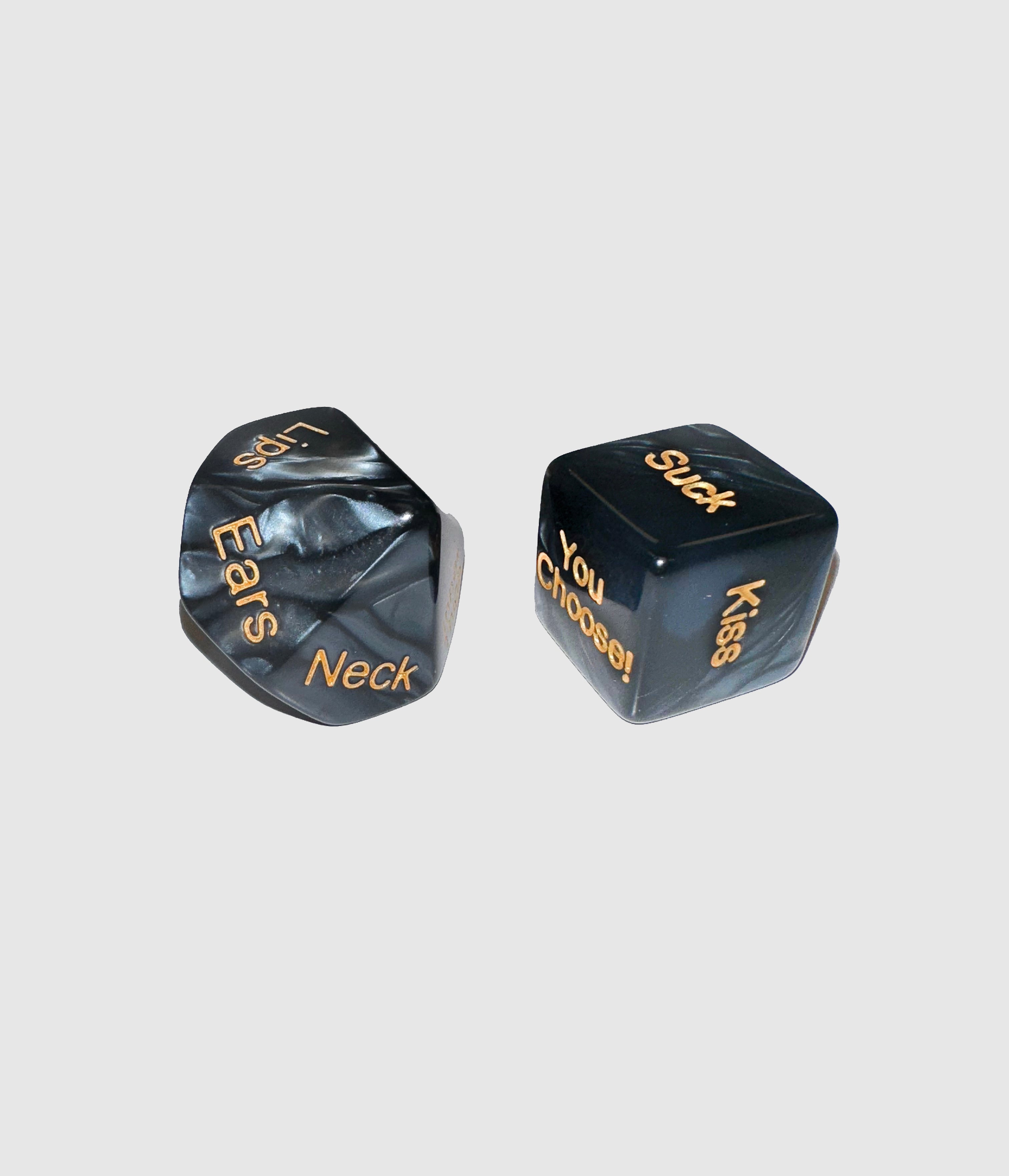 Two black dice with gold text on a light gray background