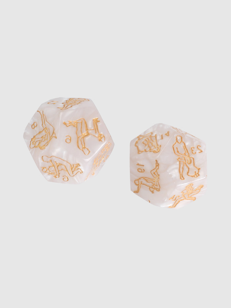 Frederick's of Hollywood Sex Dice—two white dice with gold erotic illustrations and words—add playful excitement to your intimate moments. Set against a light gray background.
