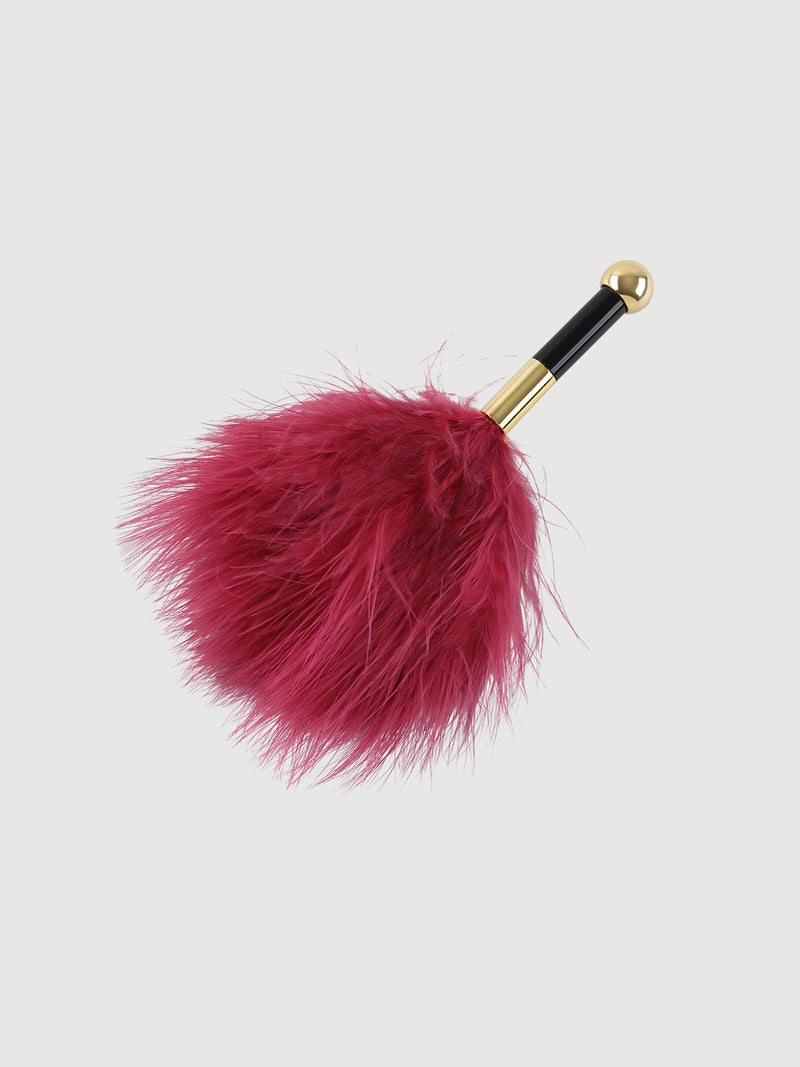 A Frederick’s of Hollywood Mini Feather Tickler, featuring pink feathers and a gold and black handle, displayed against a plain white background.