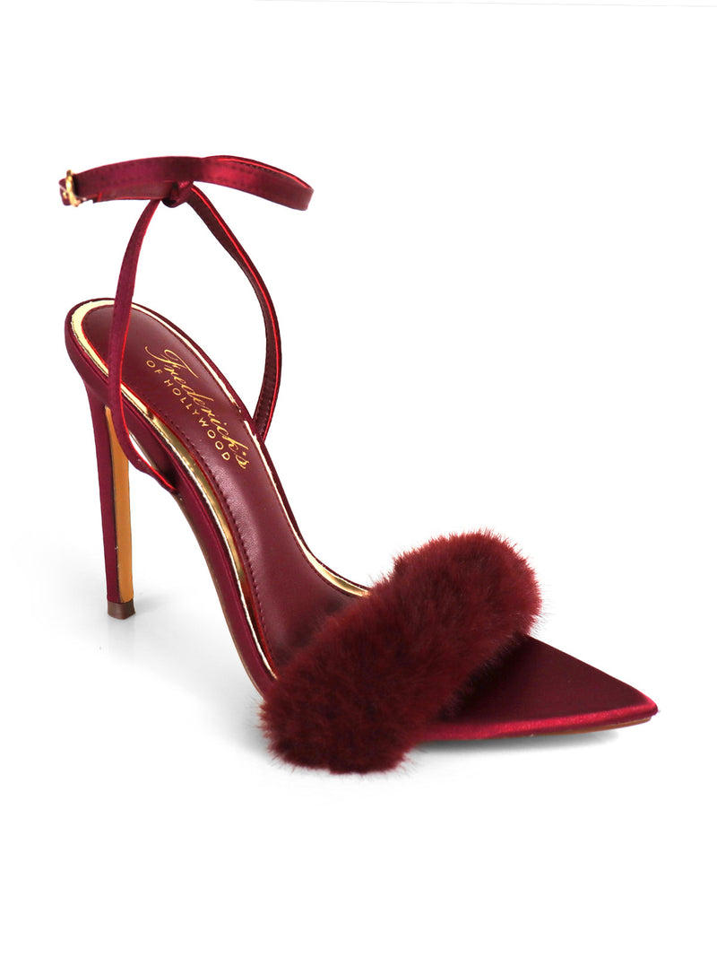 The Aileen Pointed Toe Heel by Frederick's of Hollywood features deep red satin, a slender ankle strap, a maroon fur band across the front, and a gold stiletto heel with a red tip for an elegant, timeless look.