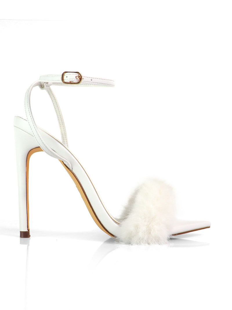 The Aileen Pointed Toe Heel by Frederick's of Hollywood is a white high-heeled sandal with an ankle strap and fluffy white fur across the toe, shown on a white background.