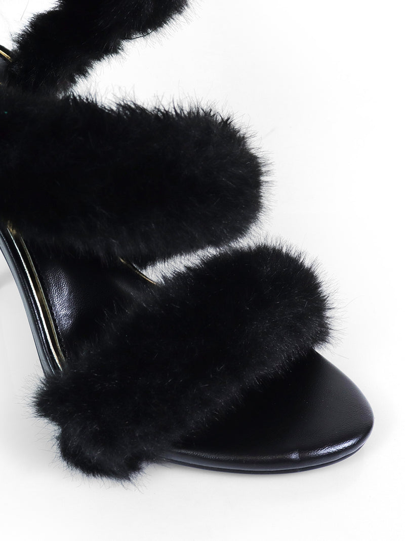 Close-up of Frederick's of Hollywood Allure Fluffy Stiletto Sandal with three thick, black faux fur straps, set against a white background—the ideal statement piece for any glamorous occasion.