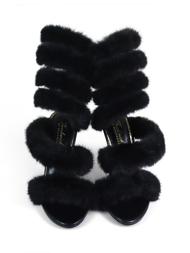 The Allure Fluffy Stiletto Sandal by Frederick’s of Hollywood features four plush black straps, creating bold statement heels that are perfect for any glamorous shoe lover.