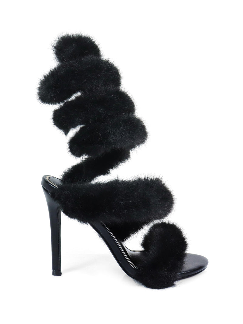 The Allure Fluffy Stiletto Sandal by Frederick's of Hollywood features three black, faux fur straps spiraling around the foot and ankle, with a sleek black heel and sole for standout, statement style.