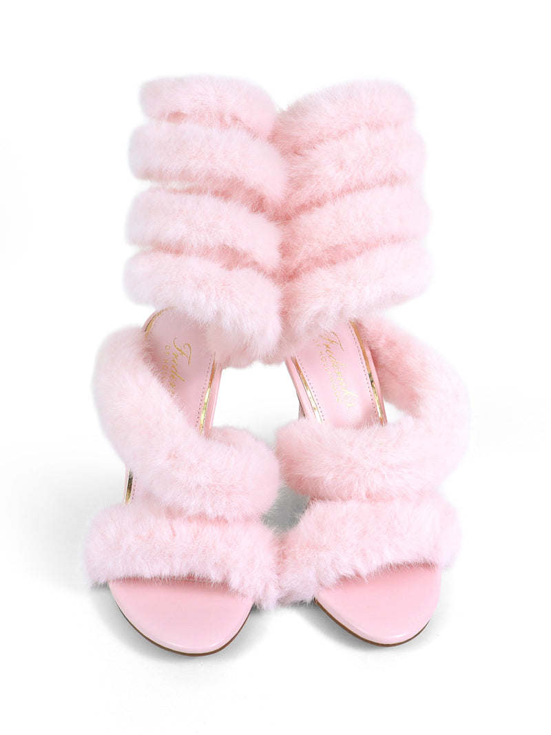 The Allure Fluffy Stiletto Sandal by Frederick's of Hollywood features thick pink faux fur straps and a pale pink sole. These glamorous open-toe high heels make a statement, showcased against a white background.