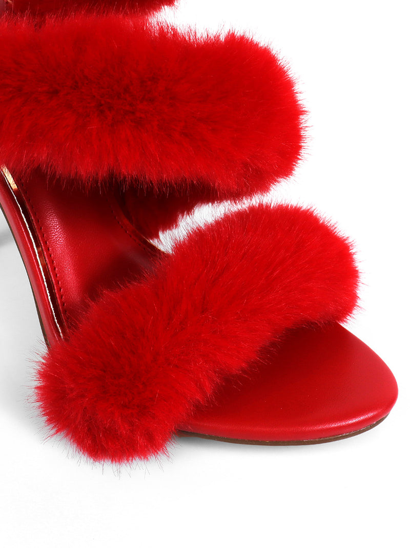 A close-up showcases the Allure Fluffy Stiletto Sandal by Frederick's of Hollywood: a red high-heeled sandal featuring three thick, fluffy fur straps and a red leather sole, perfect as statement footwear against a white background.