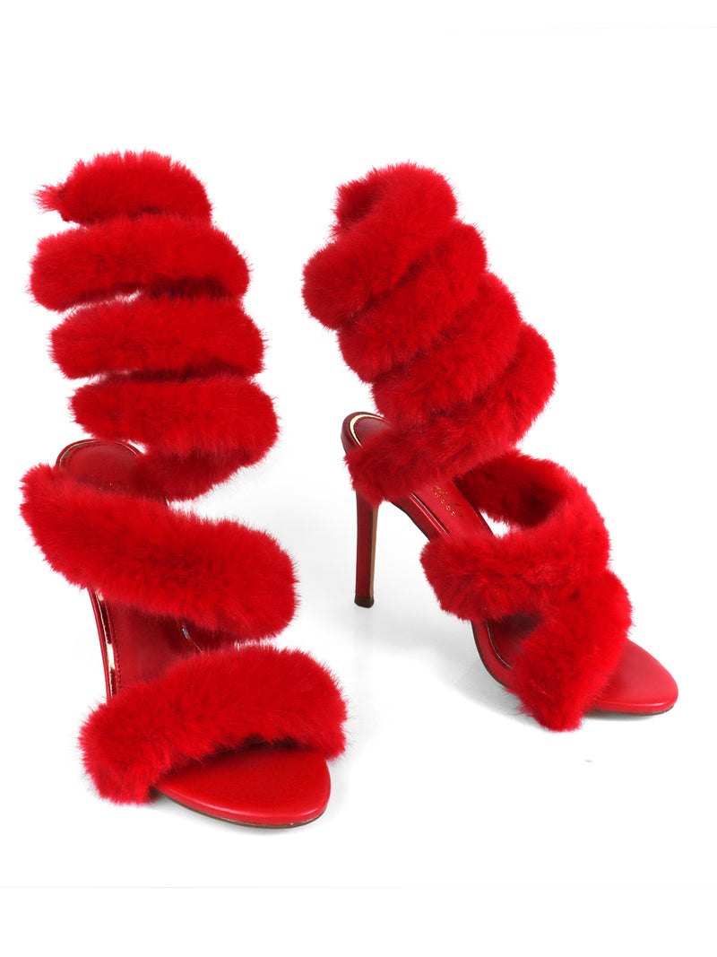 The Allure Fluffy Stiletto Sandal by Frederick's of Hollywood is a striking red high heel with thick, faux fur straps wrapping the foot and ankle, open toes, and a bold design—perfect for making a statement.