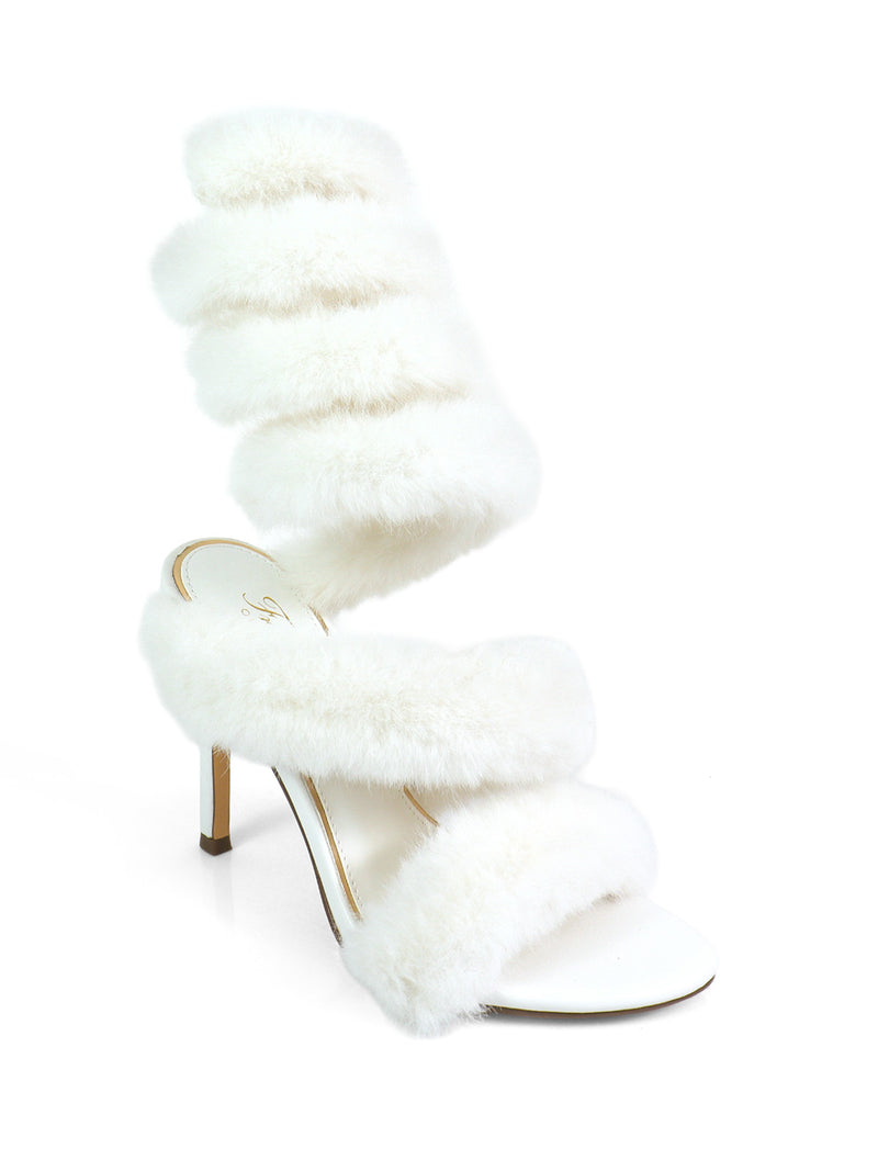 The Allure Fluffy Stiletto Sandal by Frederick's of Hollywood features three wide white faux fur straps and an open toe, making it the perfect statement heel. Shown on a white background.