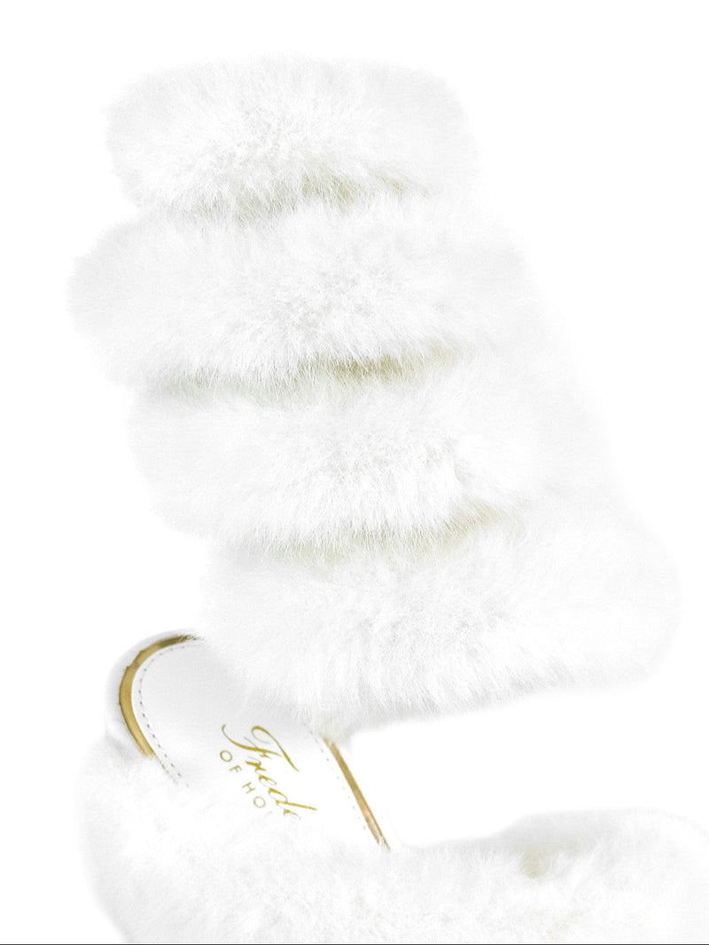 The Allure Fluffy Stiletto Sandal by Frederick's of Hollywood features three white faux fur bands and a partially visible insole with gold script, creating playful statement footwear that pops against a plain white background.