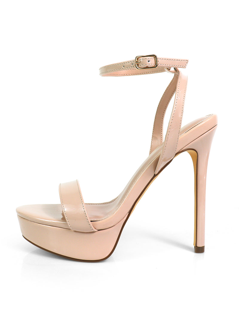 The Frederick's of Hollywood Cupid Strap Platform Heels feature a nude color, ankle strap, single toe strap, and glossy finish. Shown in side view on a white background, these high-heeled platforms offer a chic silhouette.