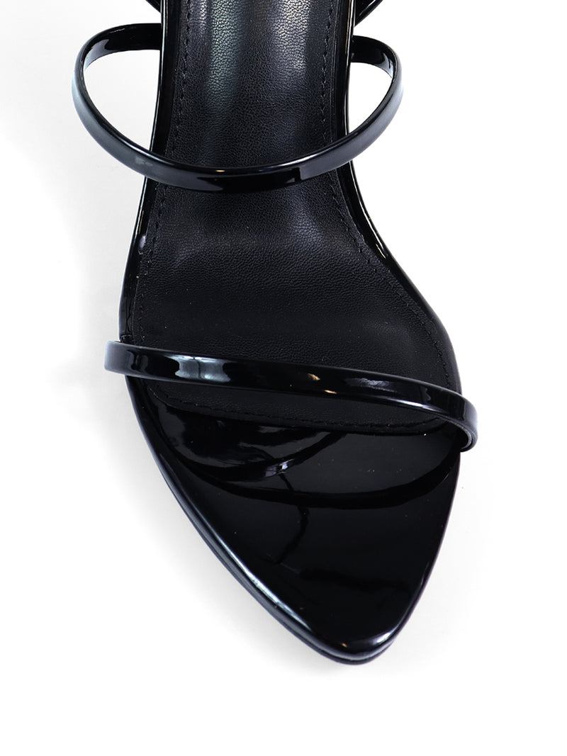 Close-up of Frederick's of Hollywood Cynthia Pointy Toe Pencil Heel—elegant heels with two thin, glossy black straps and a pointed toe, set against a white background.