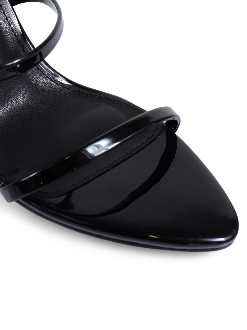 A close-up of the Cynthia Pointy Toe Pencil Heel by Frederick's of Hollywood, a black sandal with a pointy toe and two thin, shiny straps over the toe area, set against a white background.
