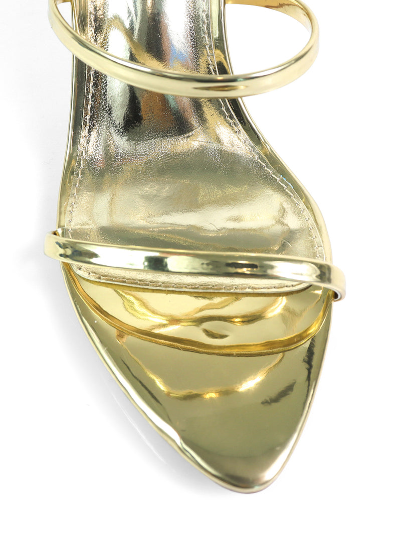 Close-up of the toe area of Frederick's of Hollywood's Cynthia Pointy Toe Pencil Heel, a shiny gold sandal with two slim straps and a pointed toe—ideal for an elegant, sophisticated look.