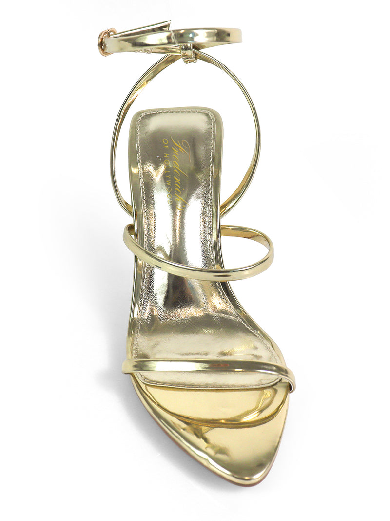 The Cynthia Pointy Toe Pencil Heel by Frederick's of Hollywood is a shiny gold high-heeled sandal with three thin foot straps and a buckled ankle strap—an elegant, versatile choice for any occasion.