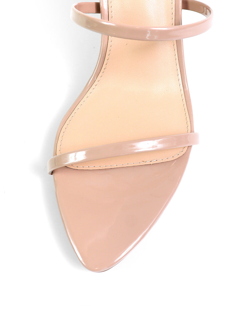 Close-up of the Cynthia Pointy Toe Pencil Heel by Frederick's of Hollywood—a nude open-toe sandal with a pencil heel and two thin straps, photographed against a white background.