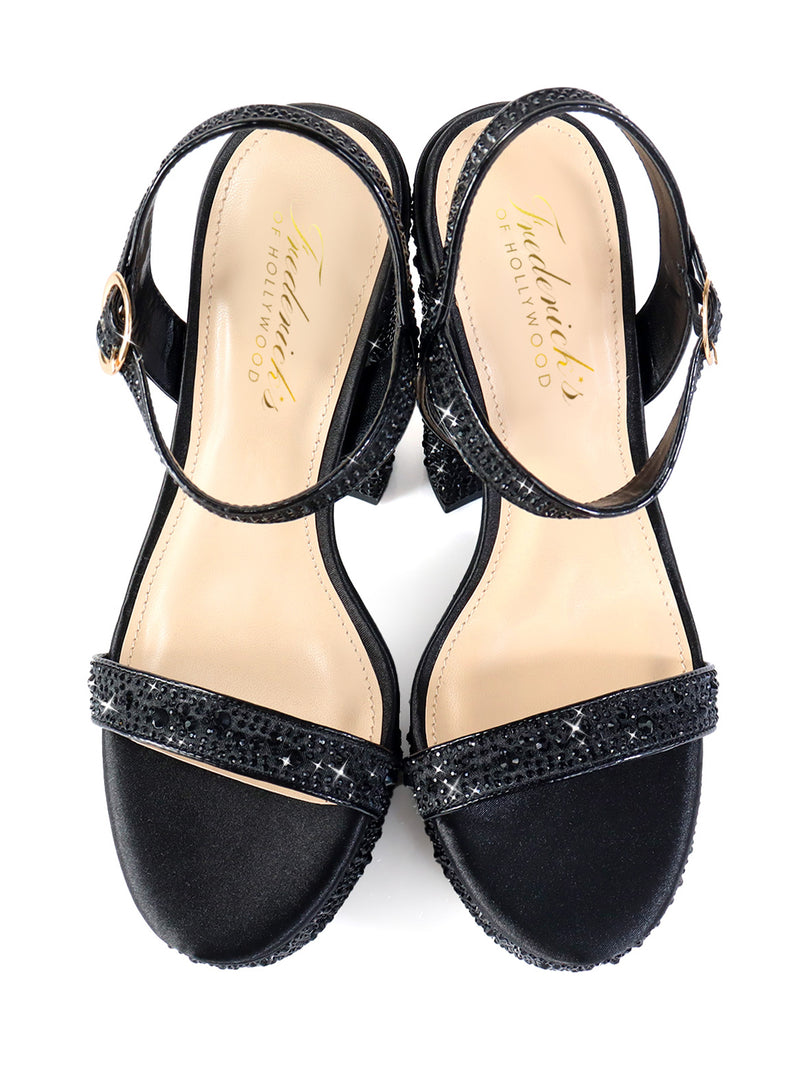 The Fabiosa Rhinestone Open Toe Platform Heel by Frederick's of Hollywood features black ankle straps, sparkling rhinestone-embellished front straps, and beige insoles—perfect for evening wear. Displayed on a white background.