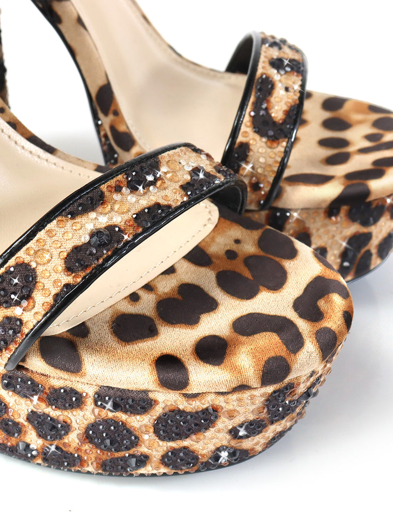 Close-up of the Frederick's of Hollywood Fabiosa Rhinestone Open Toe Platform Heel featuring a leopard print design and sparkling strap embellishments, ideal for glamorous evening wear, set against a white background.