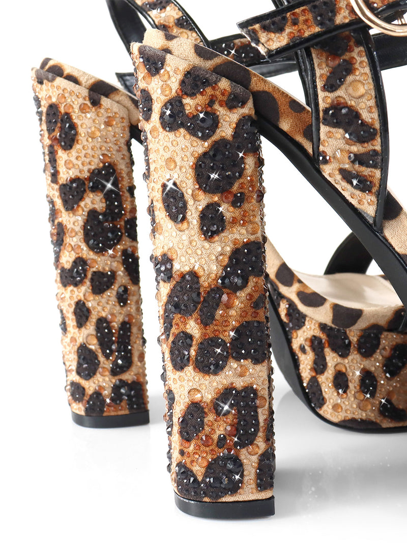 Close-up of the Fabiosa Rhinestone Open Toe Platform Heel by Frederick's of Hollywood, featuring a leopard print, sparkling rhinestone platform, and chunky straps—perfect statement heels for glamorous evenings. White background.