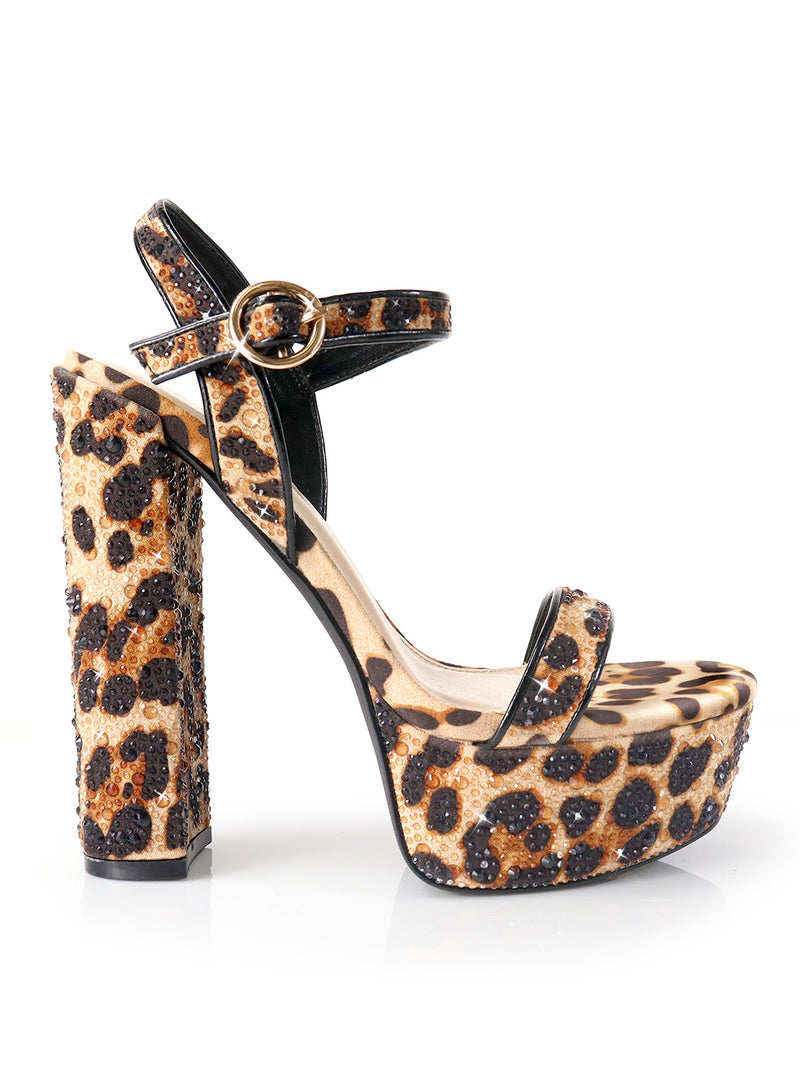 The Fabiosa Rhinestone Open Toe Platform Heel by Frederick's of Hollywood features a chunky heel, ankle strap with gold buckle, and bold leopard print—perfect for evening wear.