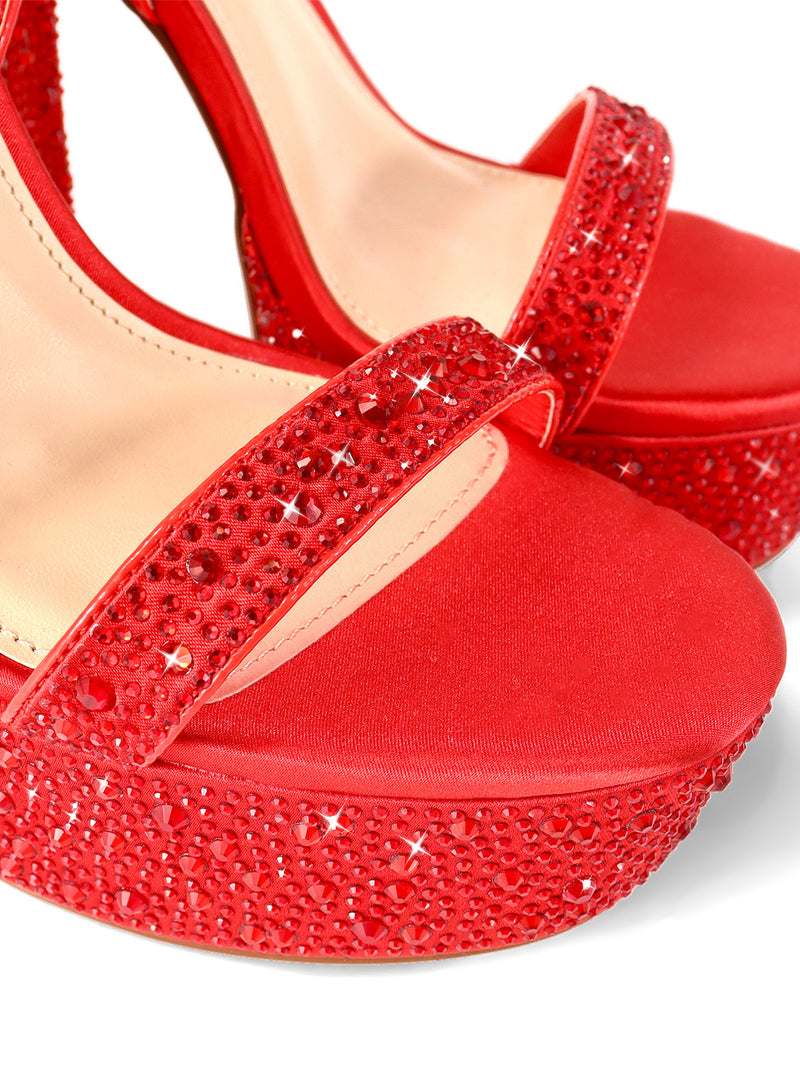 Close-up of Fabiosa Rhinestone Open Toe Platform Heel by Frederick's of Hollywood, showcasing sparkling red rhinestones on straps and platform with a satin-like finish—ideal for glamorous evening wear.