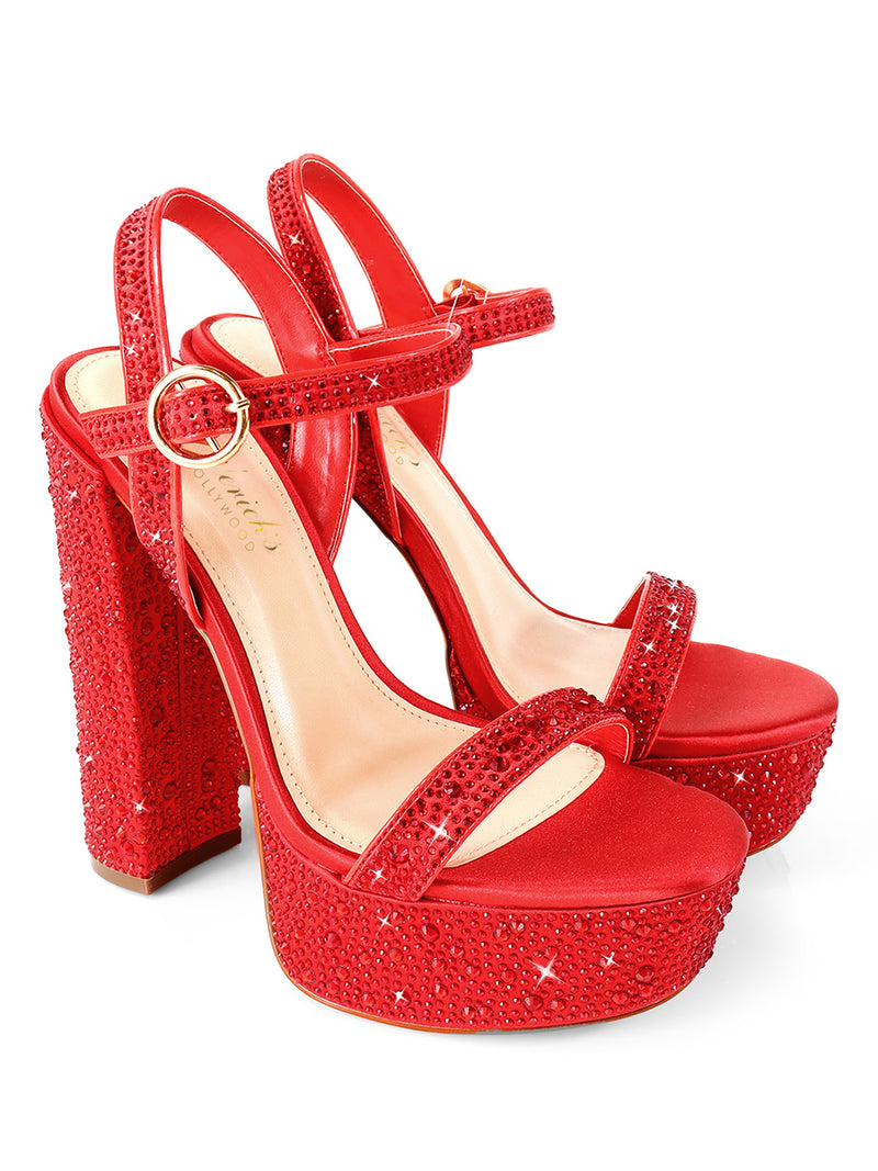 The Fabiosa Rhinestone Open Toe Platform Heel by Frederick's of Hollywood features bold red, an ankle strap, chunky heels, and sparkling red and silver rhinestones—perfect for glamorous evening wear.