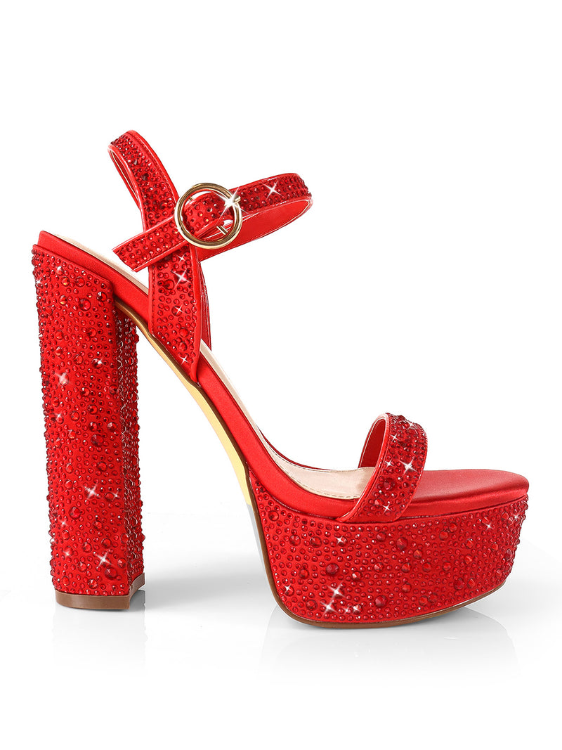 The Fabiosa Rhinestone Open Toe Platform Heel by Frederick's of Hollywood shines in bright red with a block heel, ankle strap with buckle, and toe strap—ideal for glamorous evenings.